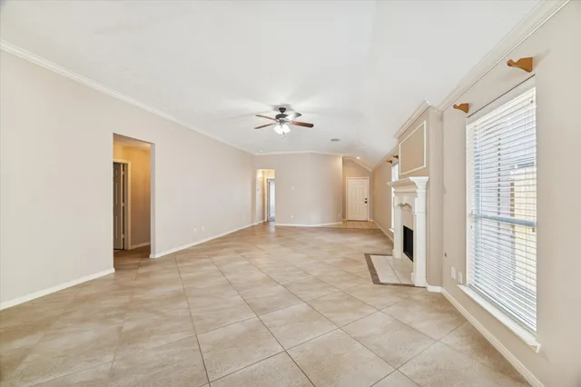 a view of a livingroom with a ceiling fan and window
