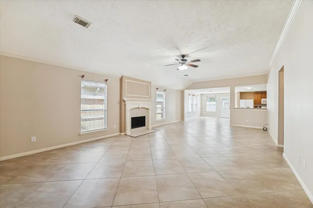 a view of livingroom with furniture chandelier fan and fire place