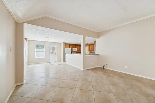 a view of a kitchen with a sink and a refrigerator