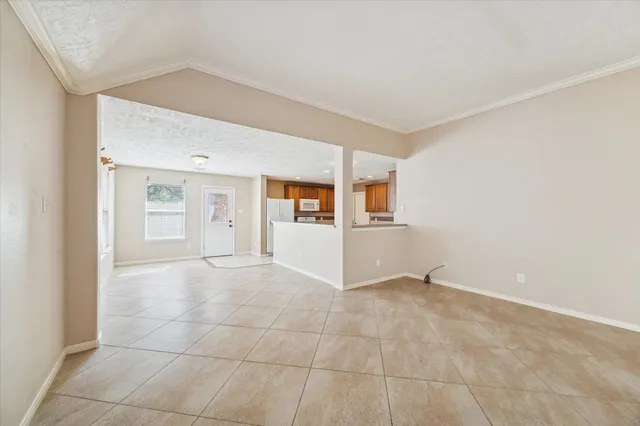 a view of a kitchen with a sink and a refrigerator