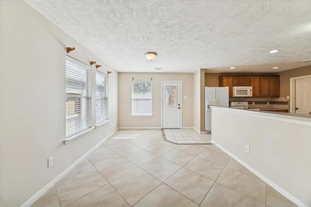 a view of kitchen with kitchen island stainless steel appliances refrigerator sink and cabinets