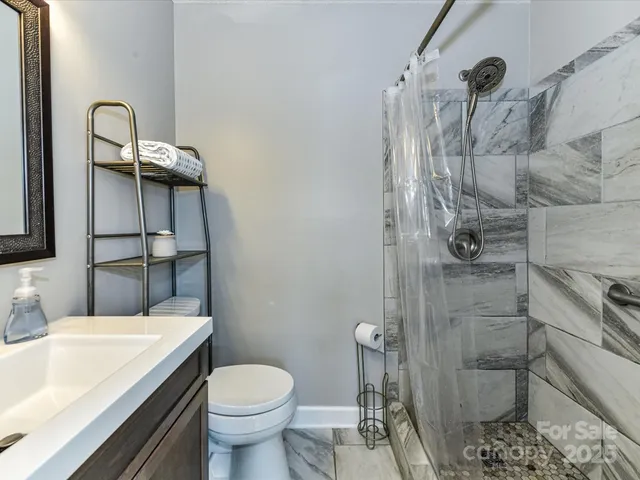 a bathroom with a toilet and shower