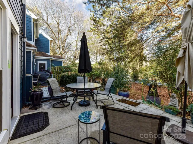 a view of a patio with a table and chairs and potted plants