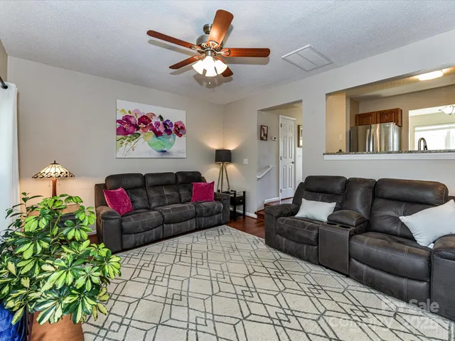 a living room with furniture and a chandelier