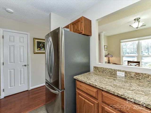 a view of kitchen island with cabinets and wooden floor