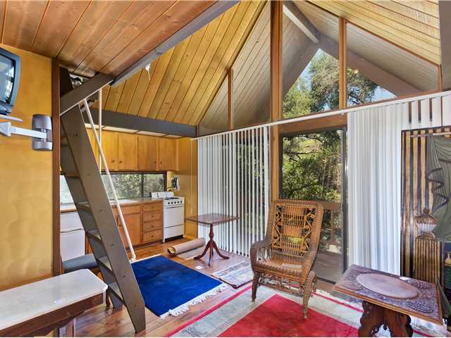 3058 Green Canyon Road Fallbrook, CA 92028 - Photo 23 of 25 Inside the Guest House. The Kitchen is to the left, the ladder to the loft is in view, and the glass doors lead to the balcony which overlooks the creek