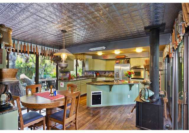 3058 Green Canyon Road Fallbrook, CA 92028 - Photo 8 of 25 Entering the charming remodeled Kitchen & Eating Area from the Great Room. The Balcony is to the right and a private deck & patio are to the left The wood floors & wood burning stove add warmth & character