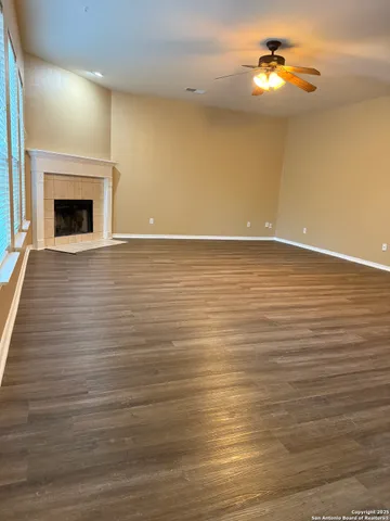 a view of an empty room with a fireplace