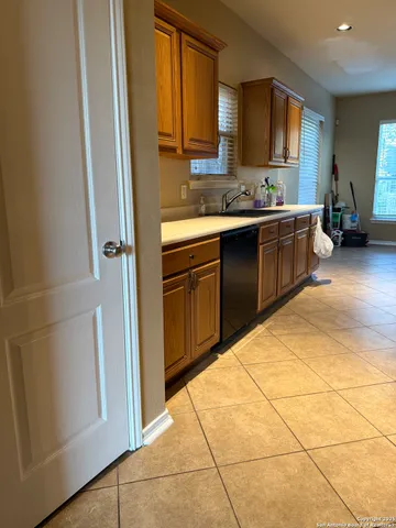 a kitchen with stainless steel appliances a sink a stove a refrigerator a window