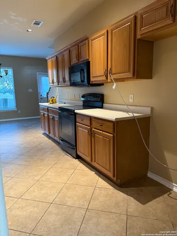 a kitchen with a sink cabinets and appliances