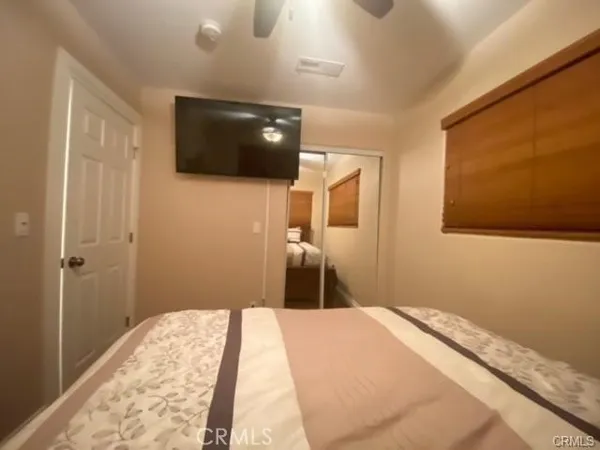 a bedroom with a bed and a television