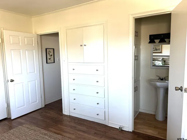 a view of walk in closet with wooden floor