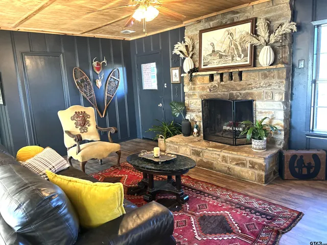 a living room with furniture and a fireplace