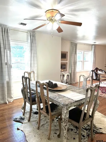 a view of a dining room with furniture and wooden floor