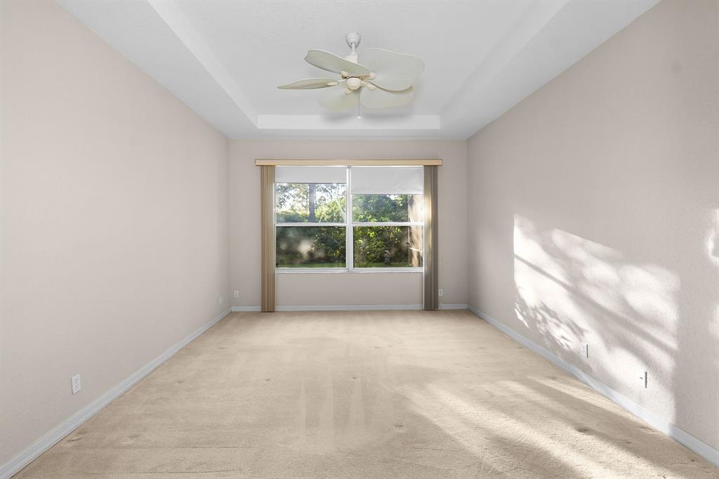 7084 Southeast Cricket Court Stuart, FL 34997 - Photo 15 of 51 an empty room with windows and ceiling fan