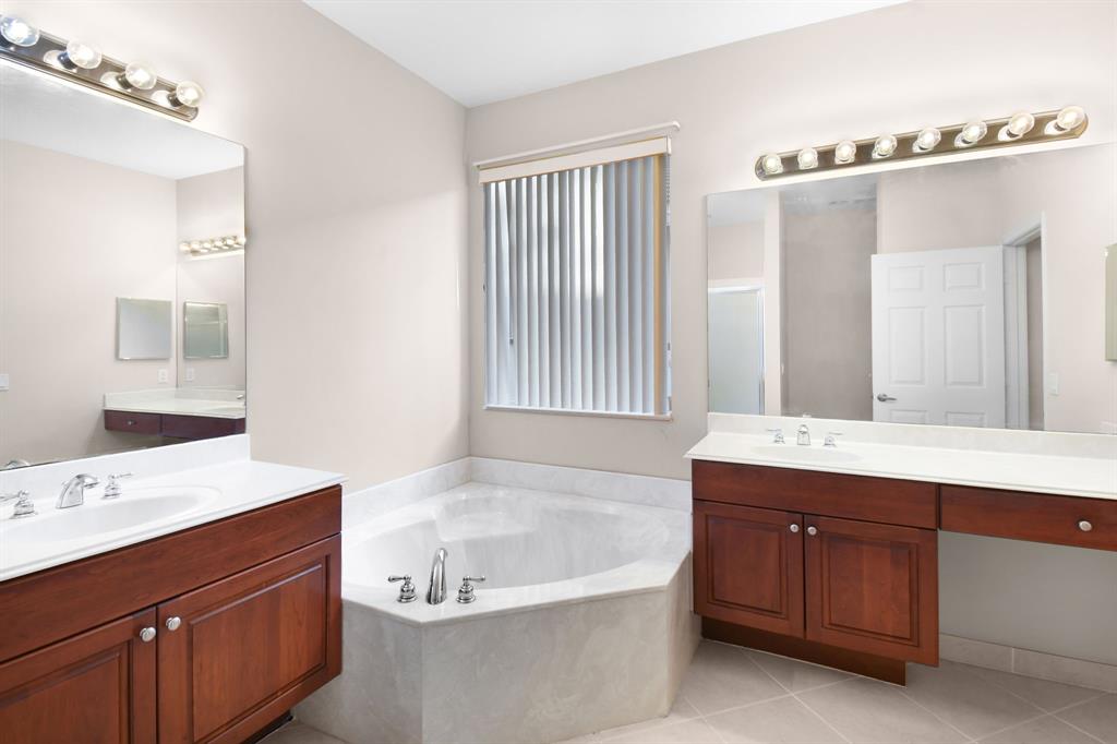 7084 Southeast Cricket Court Stuart, FL 34997 - Photo 17 of 51 a bathroom with a tub sink and mirror