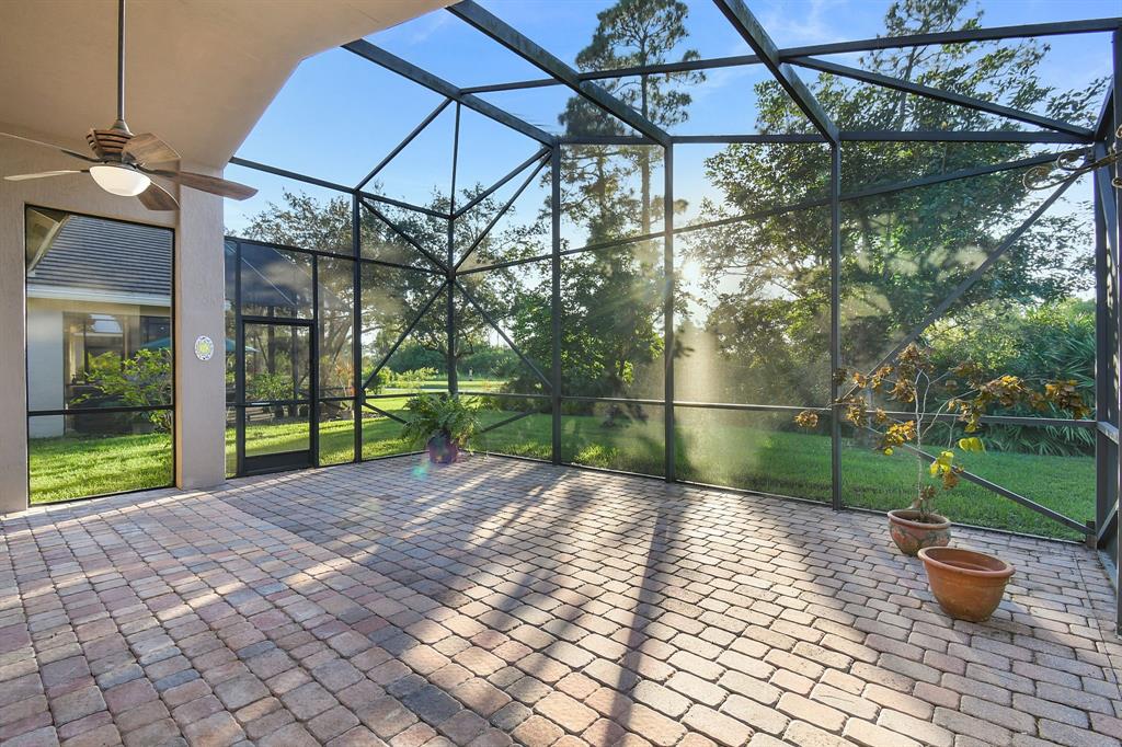 7084 Southeast Cricket Court Stuart, FL 34997 - Photo 25 of 51 a view of a backyard with potted plants