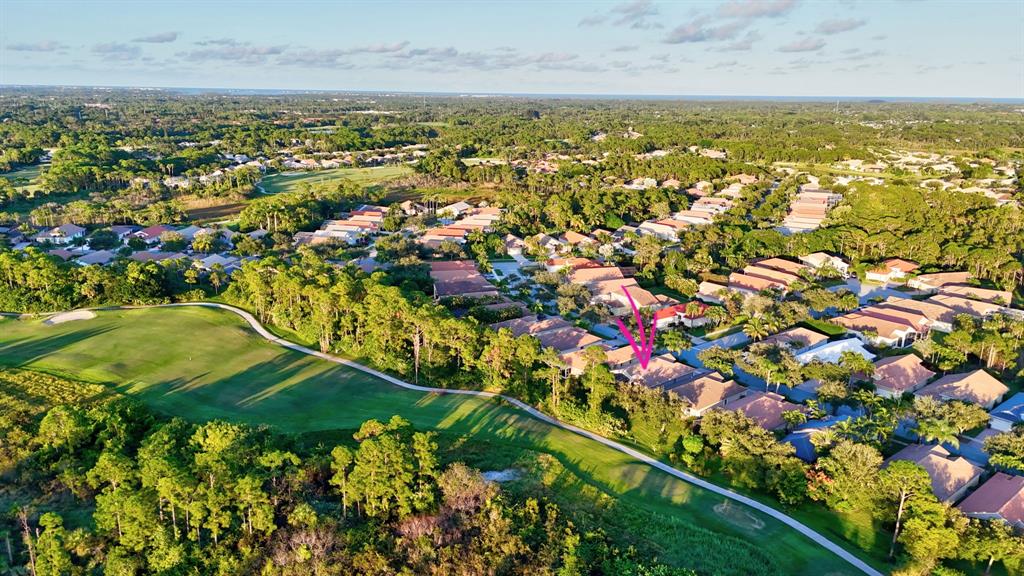 7084 Southeast Cricket Court Stuart, FL 34997 - Photo 36 of 51 an aerial view of residential houses with outdoor space and trees