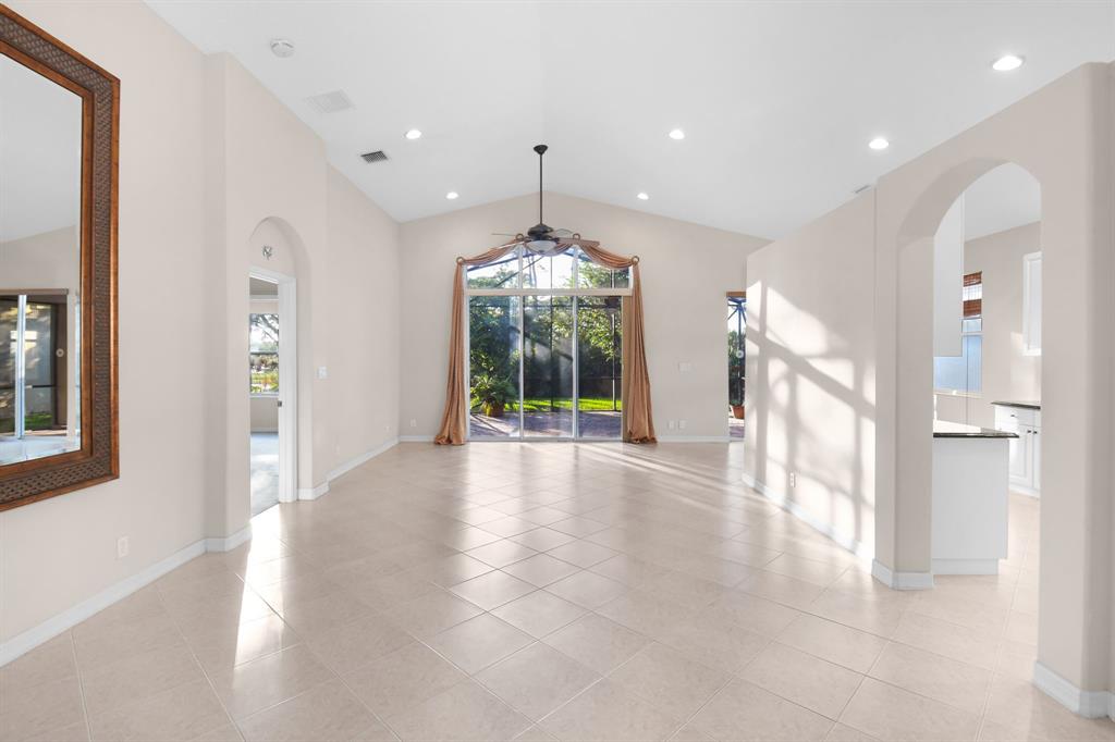 7084 Southeast Cricket Court Stuart, FL 34997 - Photo 4 of 51 a view of an empty room with glass door and windows