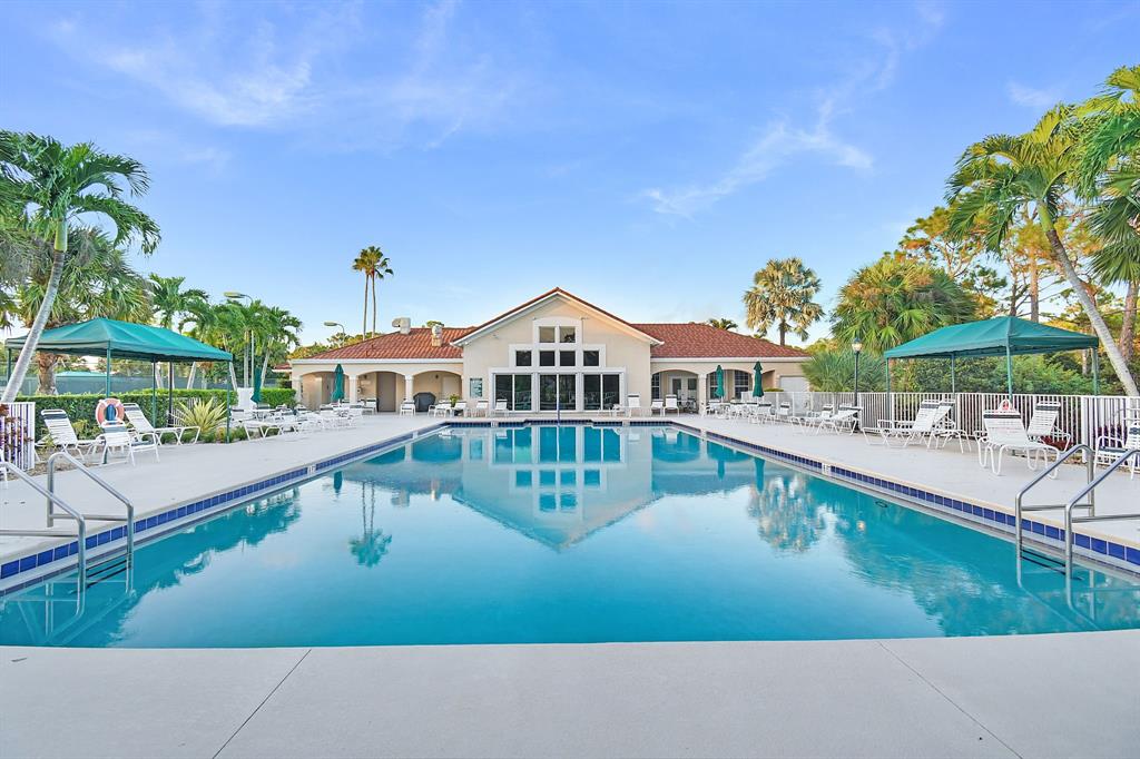 7084 Southeast Cricket Court Stuart, FL 34997 - Photo 44 of 51 a view of a house with pool and chairs