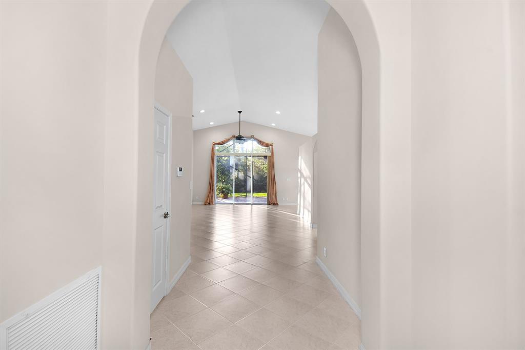 7084 Southeast Cricket Court Stuart, FL 34997 - Photo 6 of 51 a view of a hallway with wooden floor