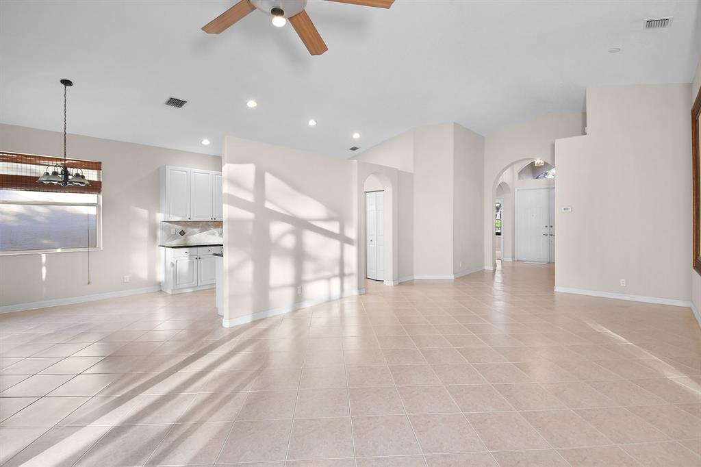 7084 Southeast Cricket Court Stuart, FL 34997 - Photo 8 of 51 a view of an empty room and kitchen view