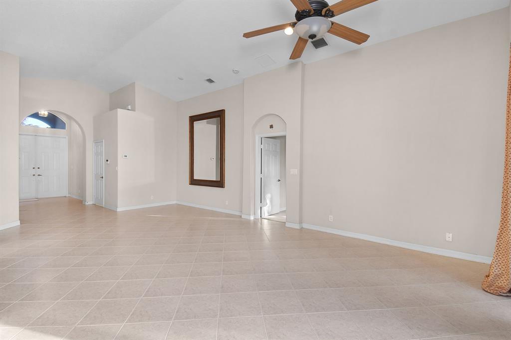 7084 Southeast Cricket Court Stuart, FL 34997 - Photo 9 of 51 a view of an empty room with a ceiling fan