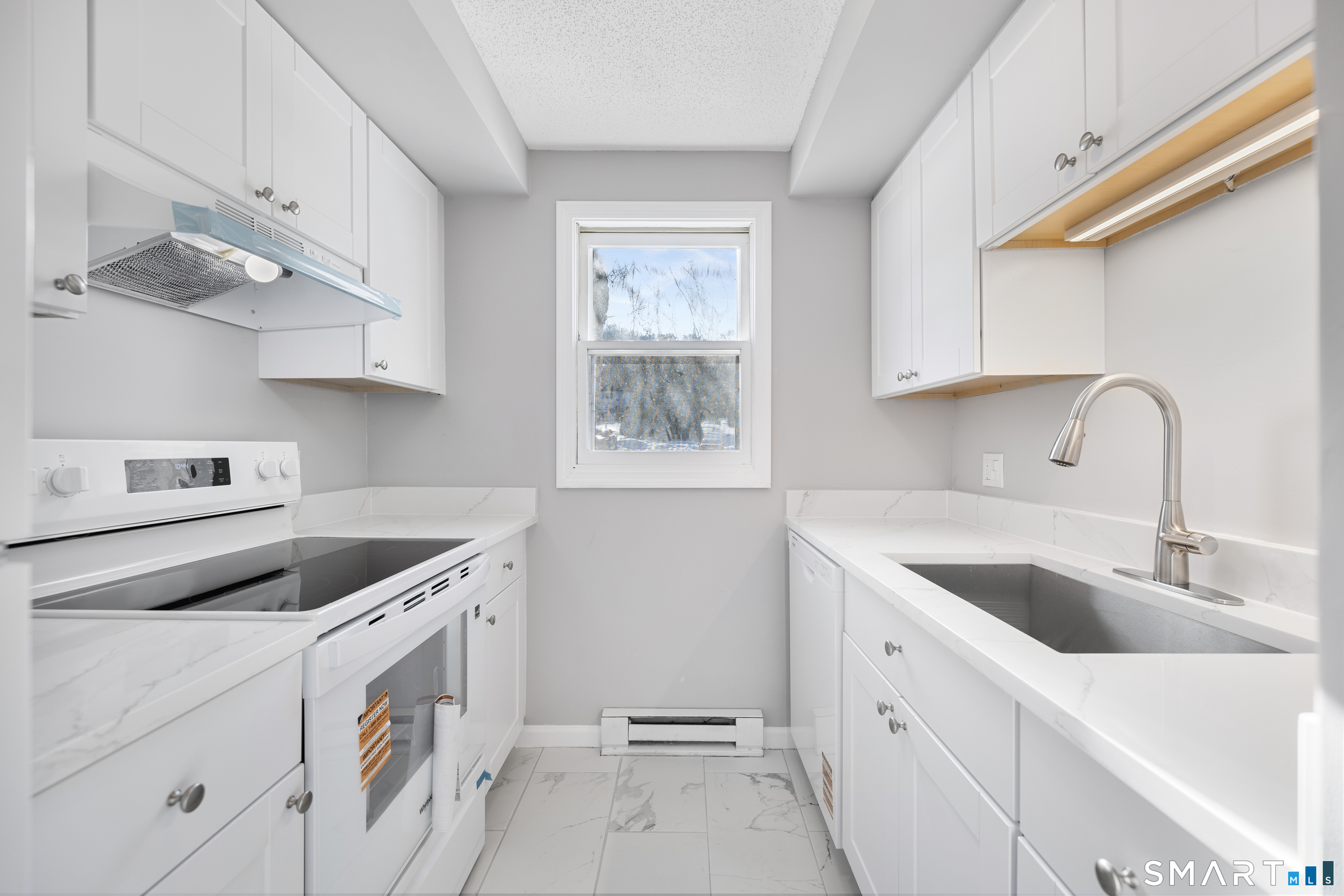 181 Sherbrook Street, Unit A3 Bristol, CT 06010 - Photo 3 of 18 a kitchen with cabinets appliances a sink and a window