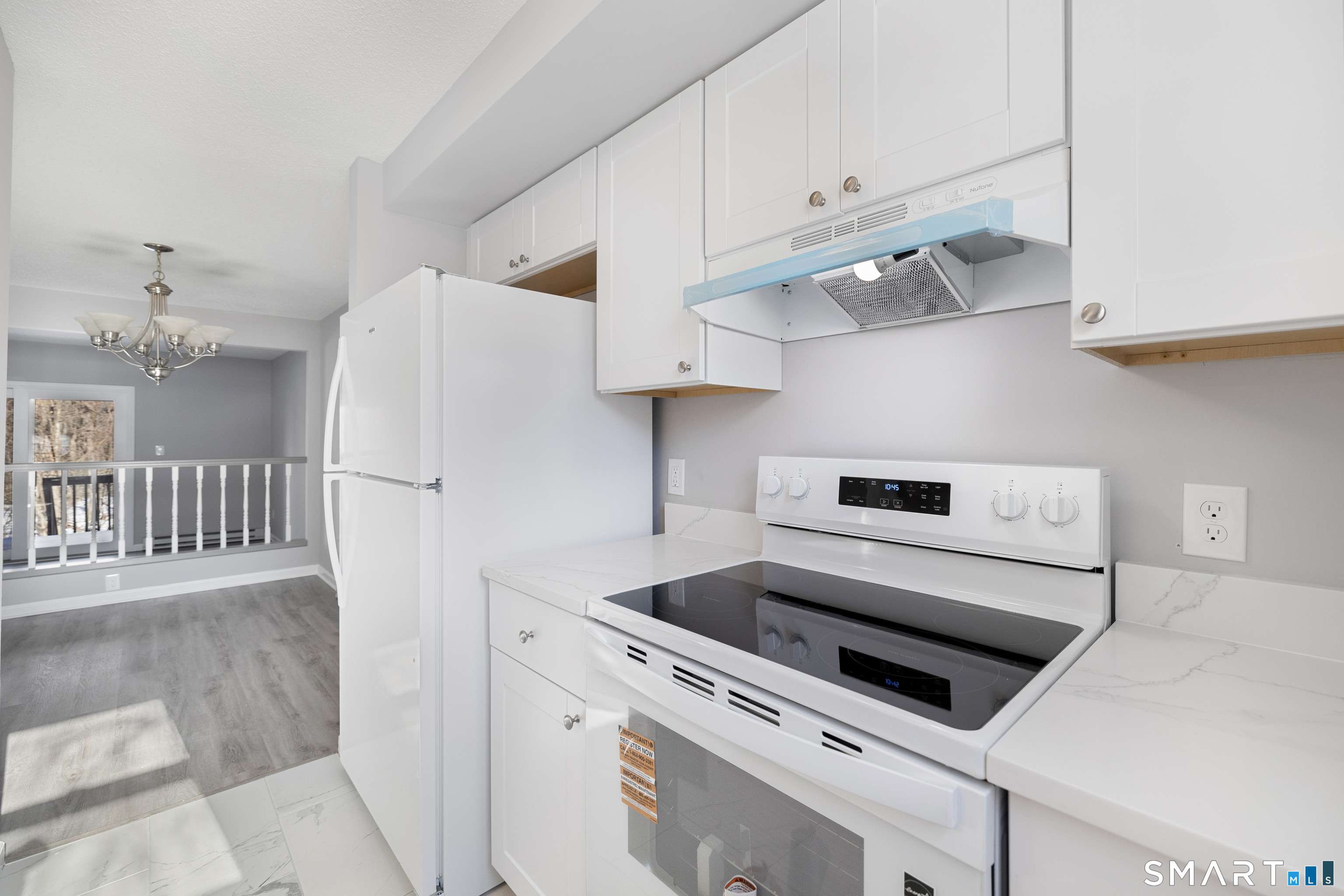 181 Sherbrook Street, Unit A3 Bristol, CT 06010 - Photo 4 of 18 a kitchen with white cabinets and white appliances