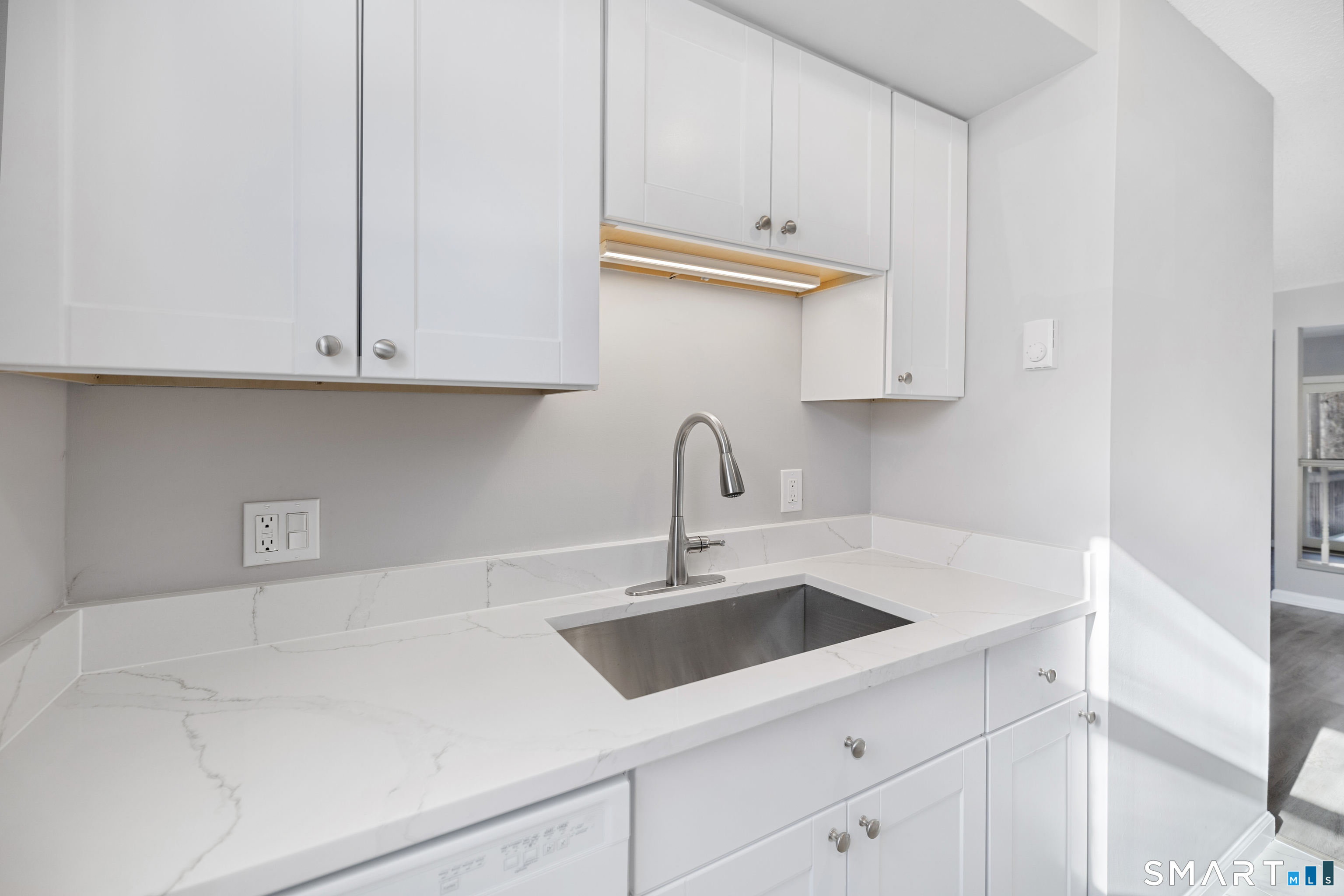 181 Sherbrook Street, Unit A3 Bristol, CT 06010 - Photo 5 of 18 a kitchen with a sink and cabinets