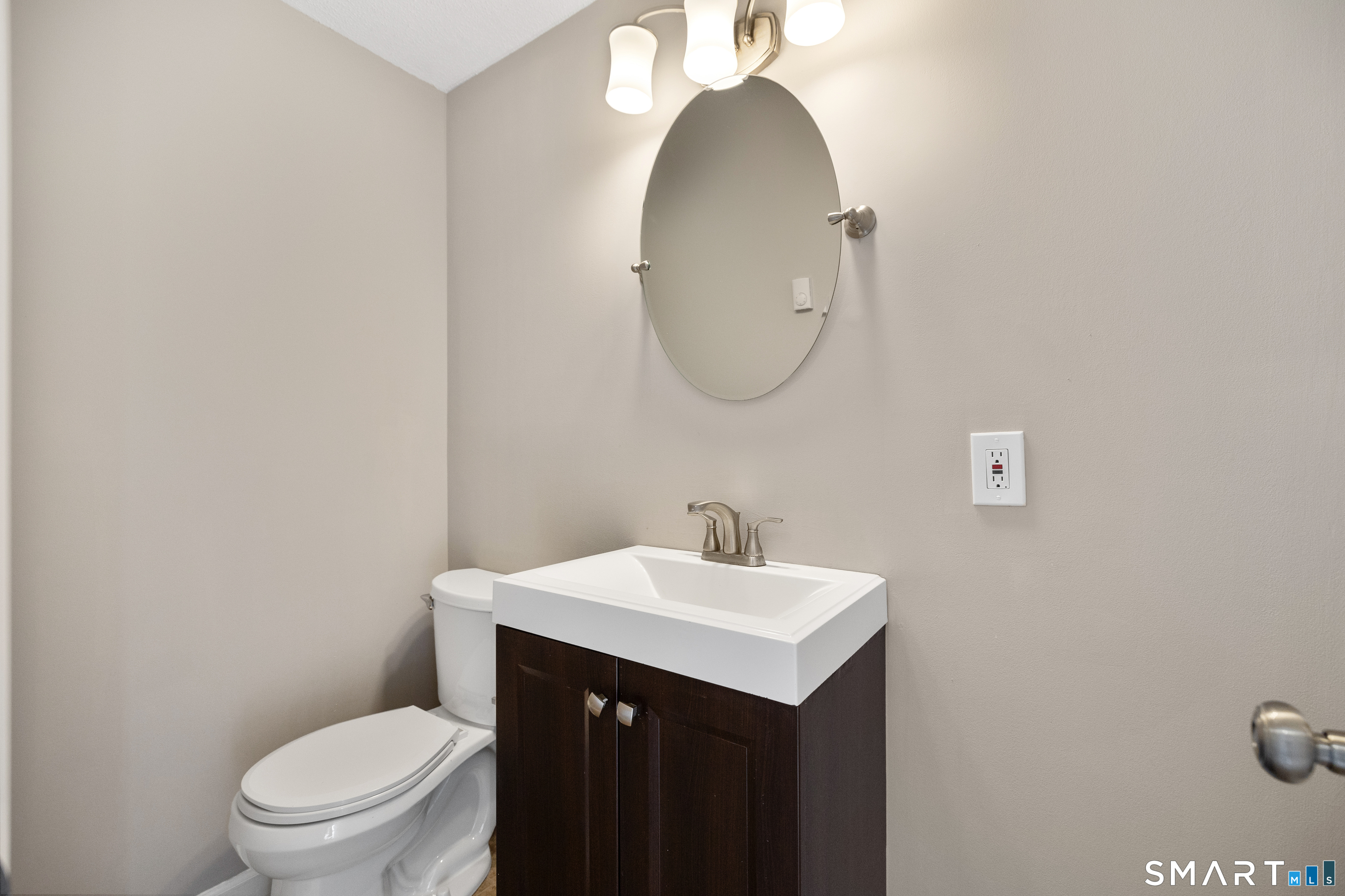 181 Sherbrook Street, Unit A3 Bristol, CT 06010 - Photo 9 of 18 a bathroom with a sink a toilet and a mirror