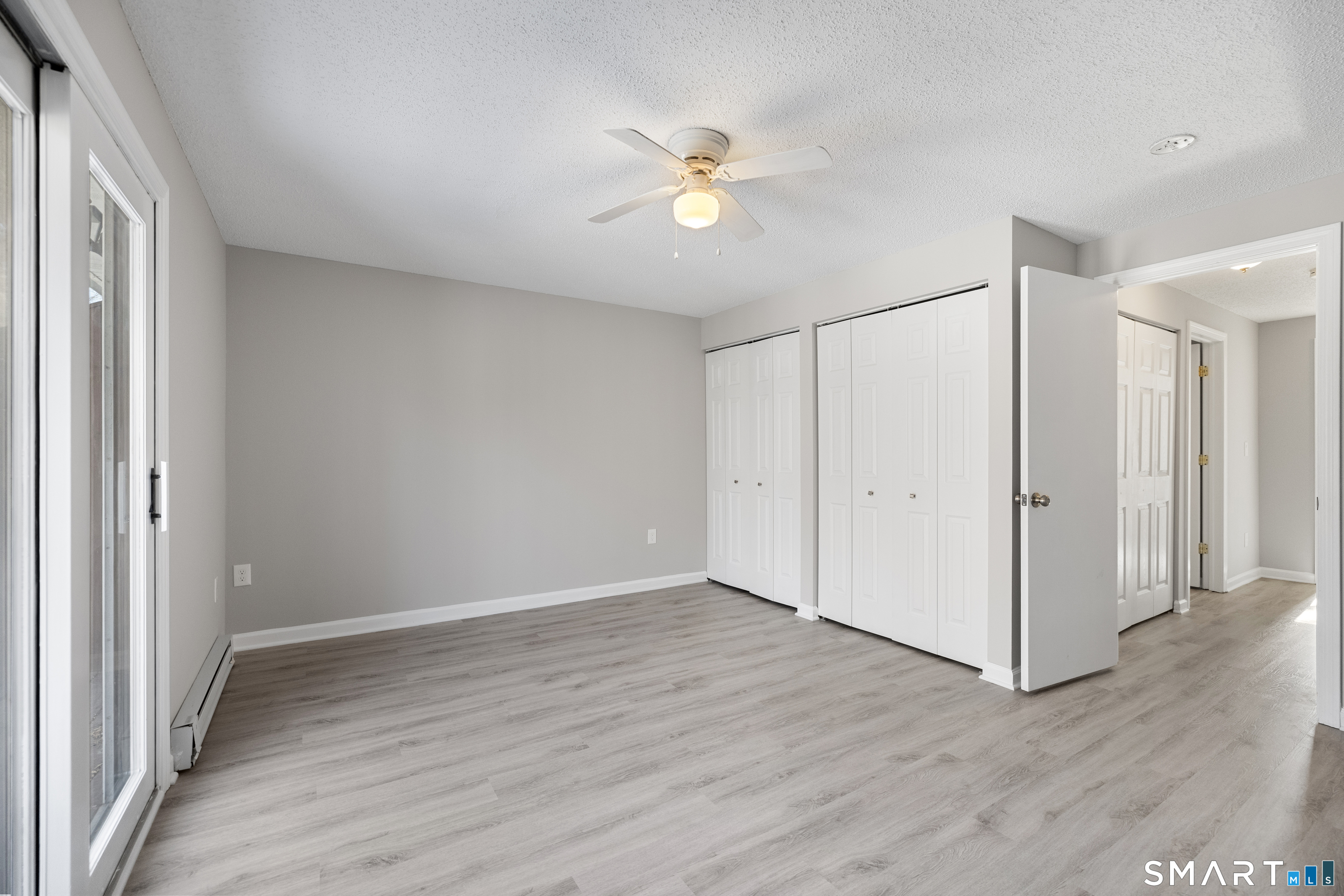 181 Sherbrook Street, Unit A3 Bristol, CT 06010 - Photo 10 of 18 a view of an empty room with wooden floor