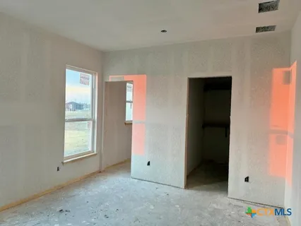 an empty room with windows and flowerpot