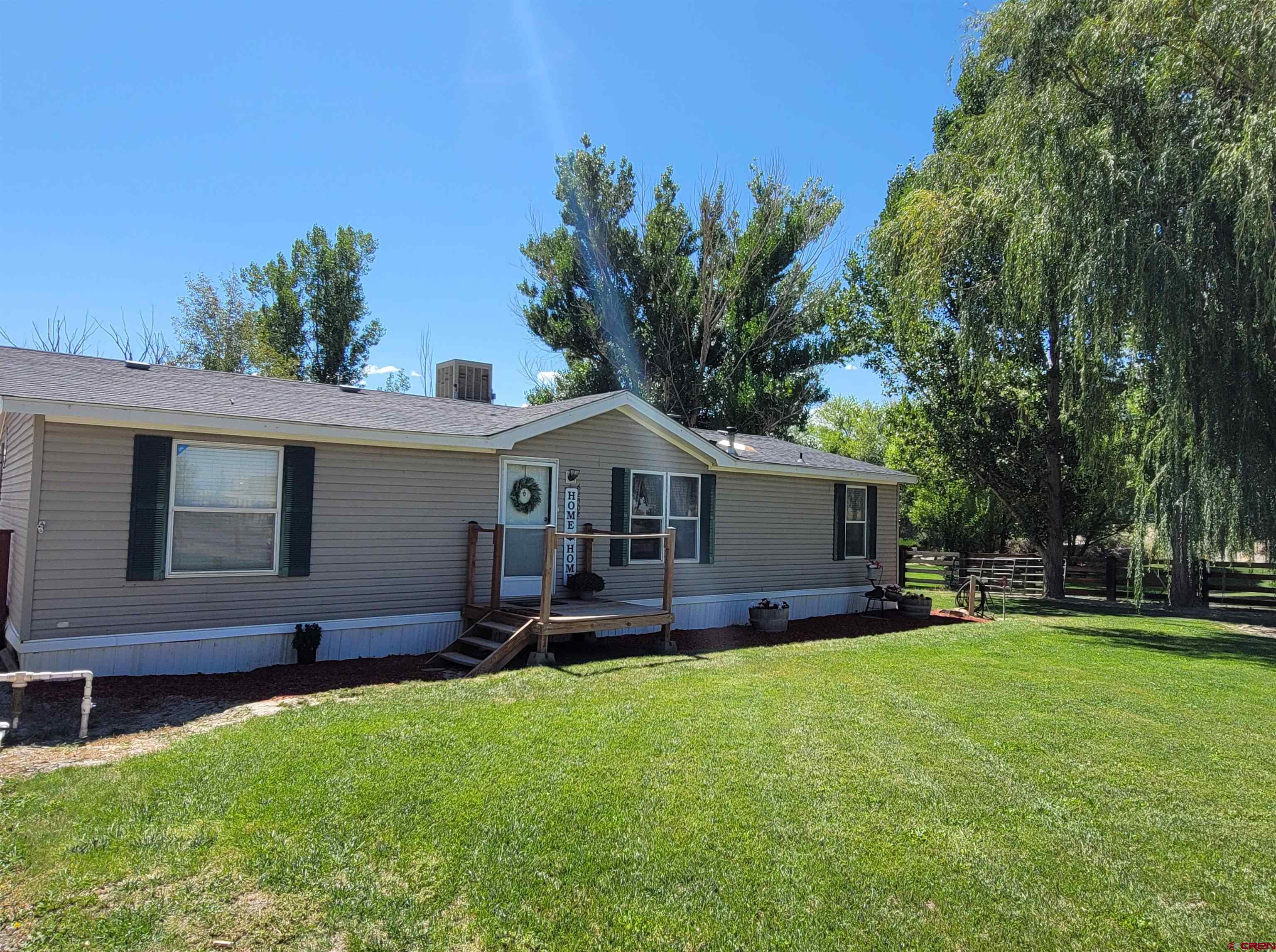 62302 David Road Olathe, CO 81425 - Photo 1 of 15 a front view of house with yard and green space