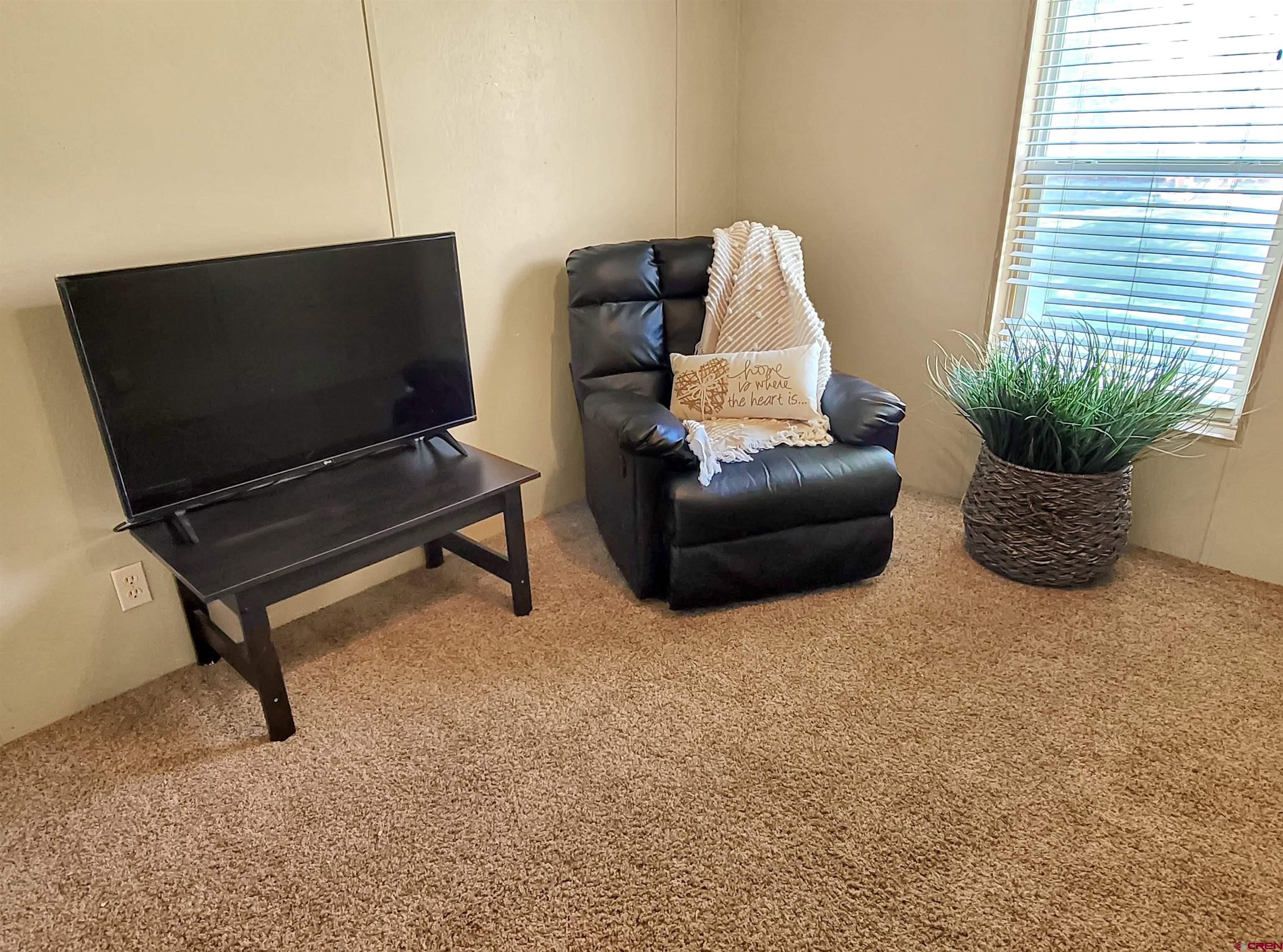62302 David Road Olathe, CO 81425 - Photo 13 of 15 a living room with furniture and a flat screen tv