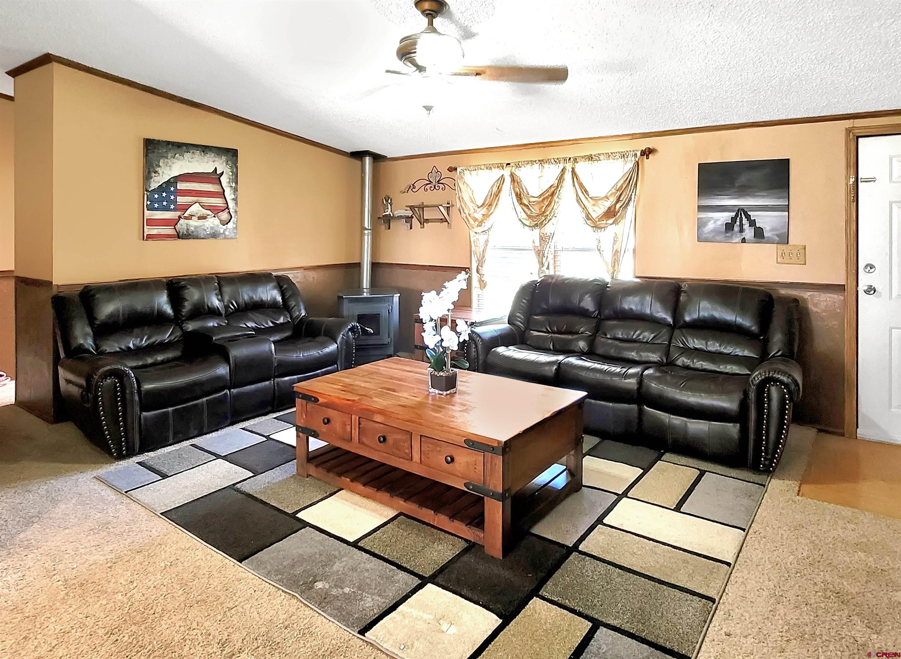 62302 David Road Olathe, CO 81425 - Photo 4 of 15 a living room with furniture a rug and a window