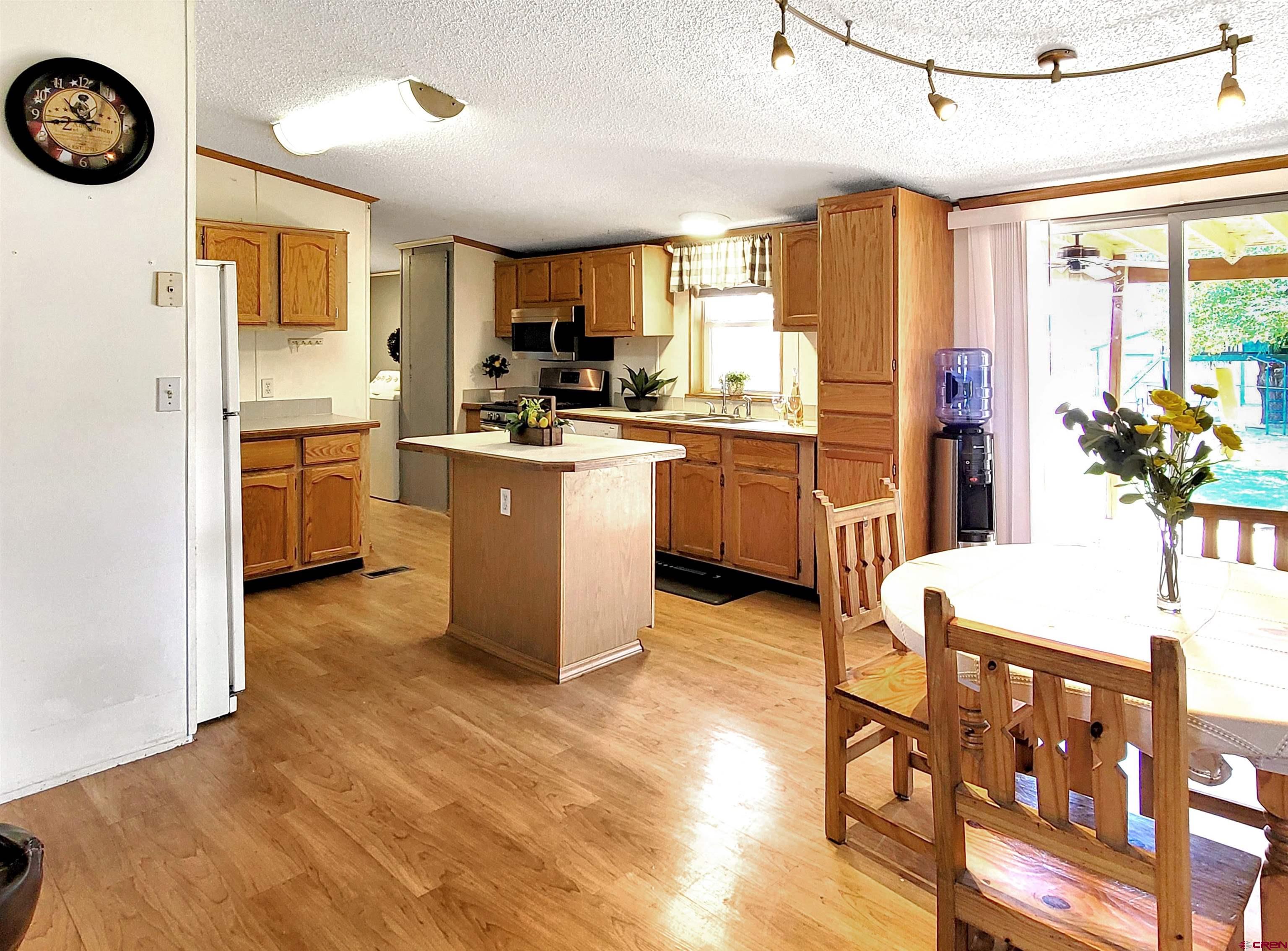 62302 David Road Olathe, CO 81425 - Photo 5 of 15 a kitchen with cabinets and wooden floor