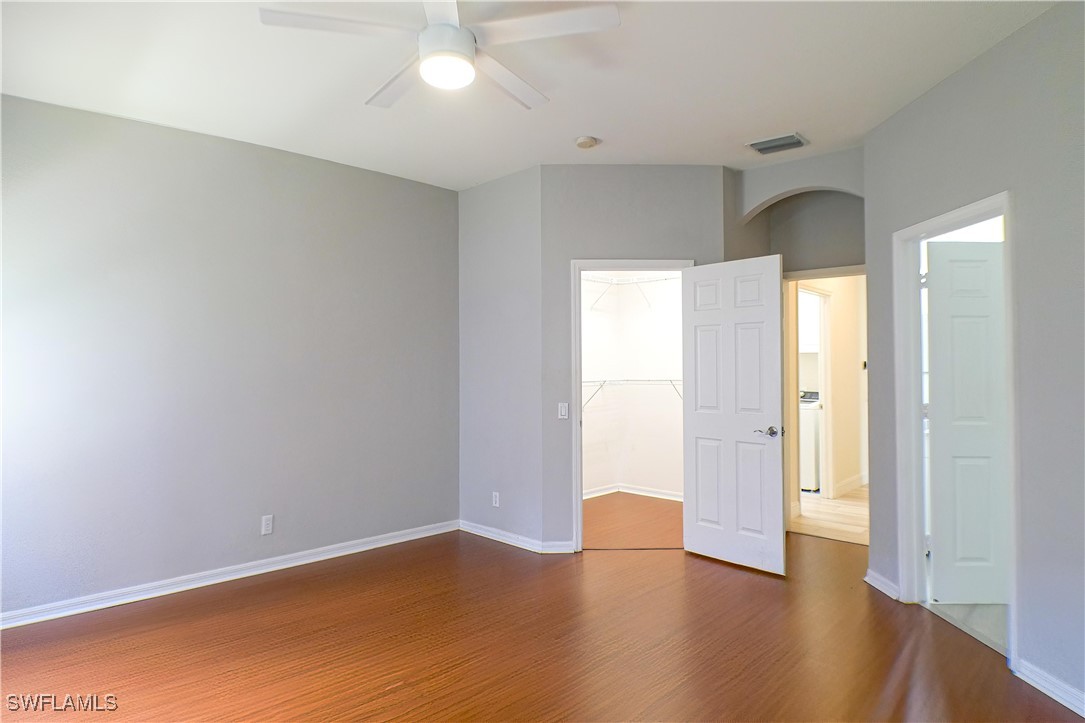 8876 Falcon Pointe Loop Fort Myers, FL 33912 - Photo 11 of 31 an empty room with wooden floor and windows