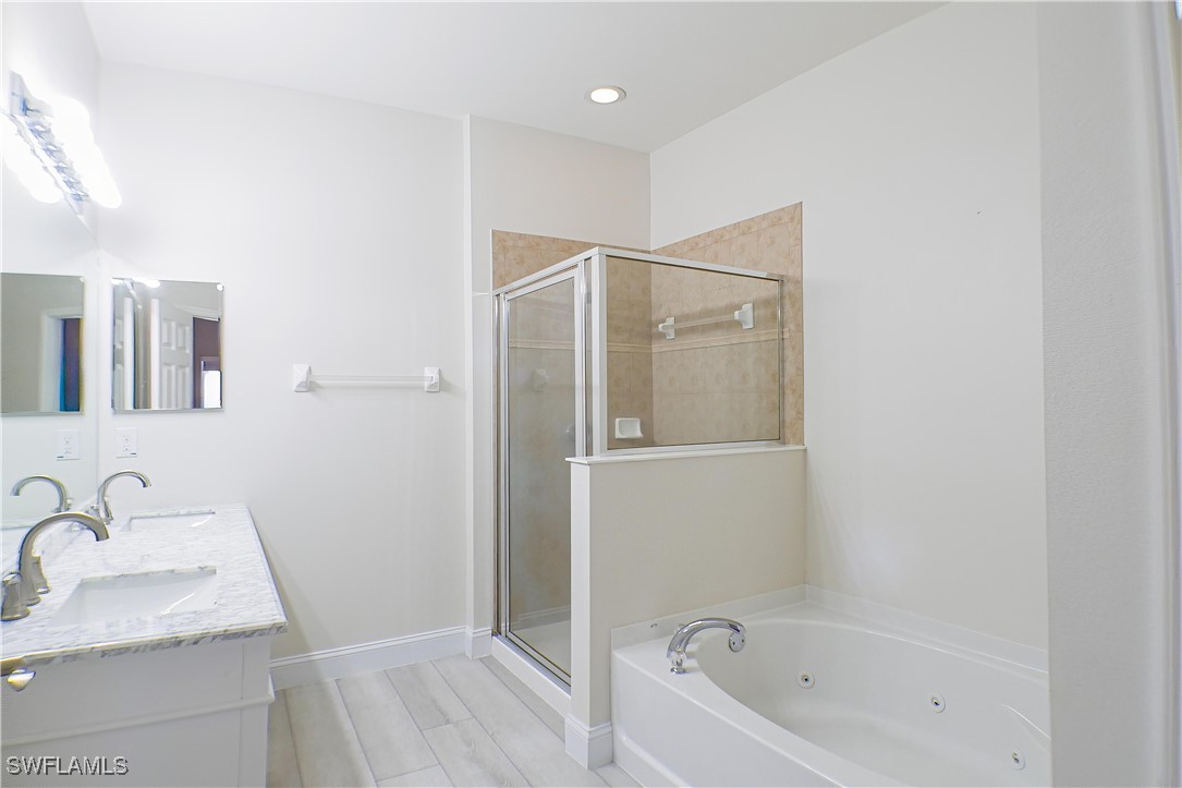 8876 Falcon Pointe Loop Fort Myers, FL 33912 - Photo 14 of 31 a bathroom with a granite countertop sink a mirror and shower