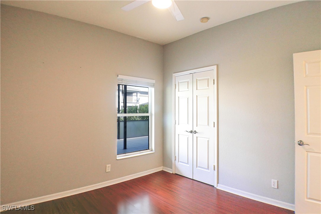 8876 Falcon Pointe Loop Fort Myers, FL 33912 - Photo 15 of 31 an empty room with wooden floor and windows