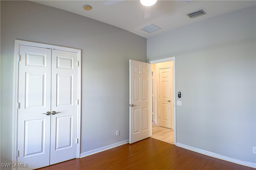 8876 Falcon Pointe Loop Fort Myers, FL 33912 - Photo 16 of 31 an empty room with wooden floor