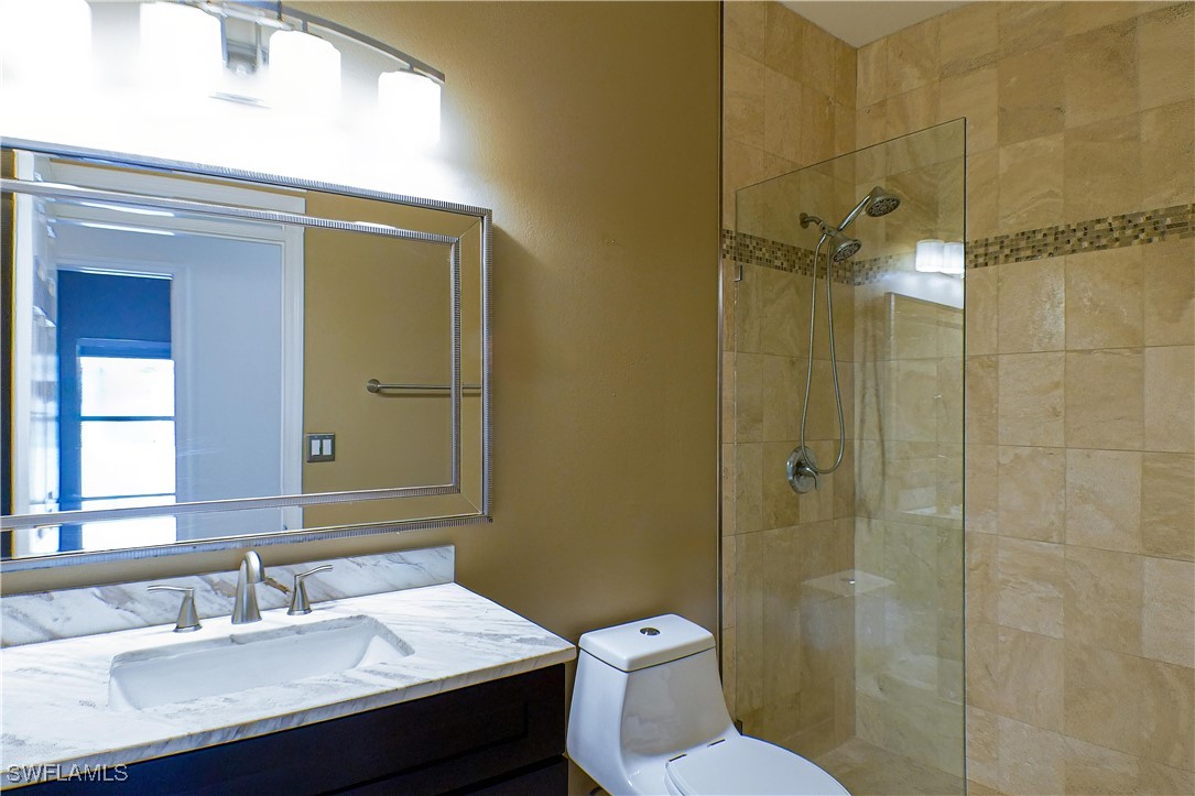 8876 Falcon Pointe Loop Fort Myers, FL 33912 - Photo 17 of 31 a bathroom with a sink a toilet and shower