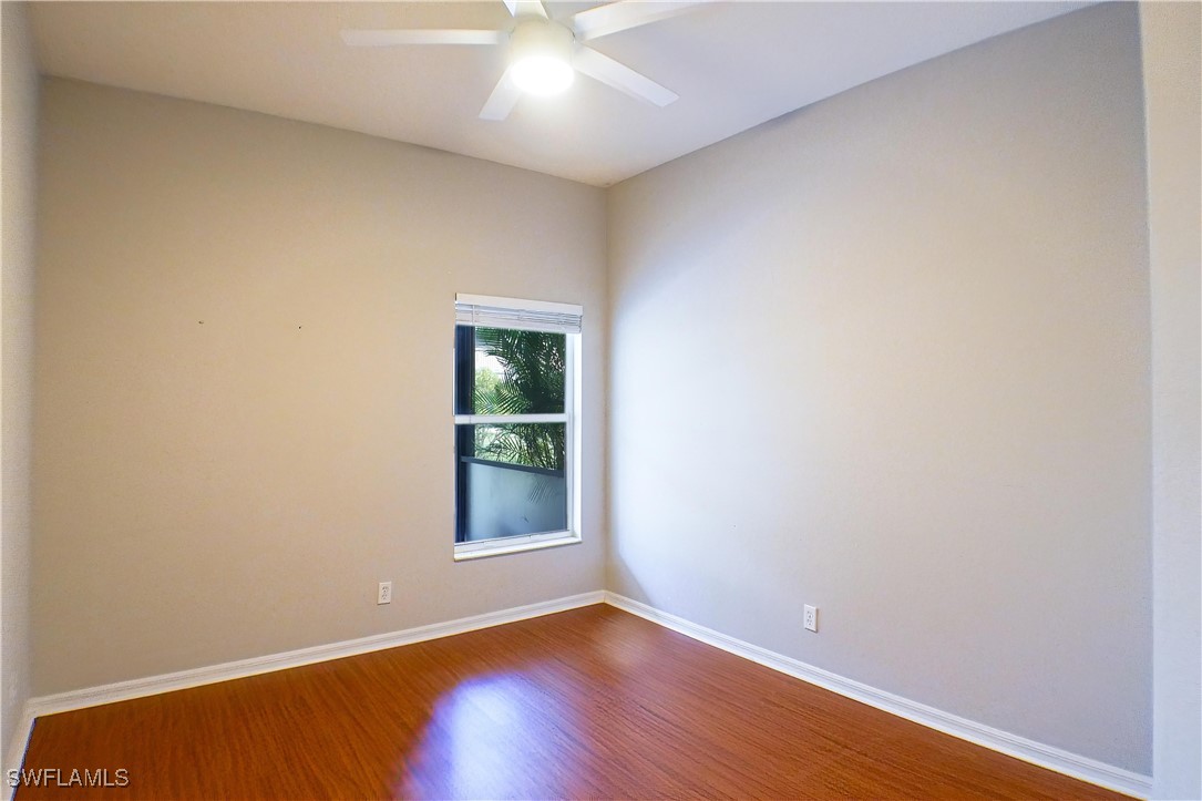 8876 Falcon Pointe Loop Fort Myers, FL 33912 - Photo 18 of 31 an empty room with wooden floor and windows