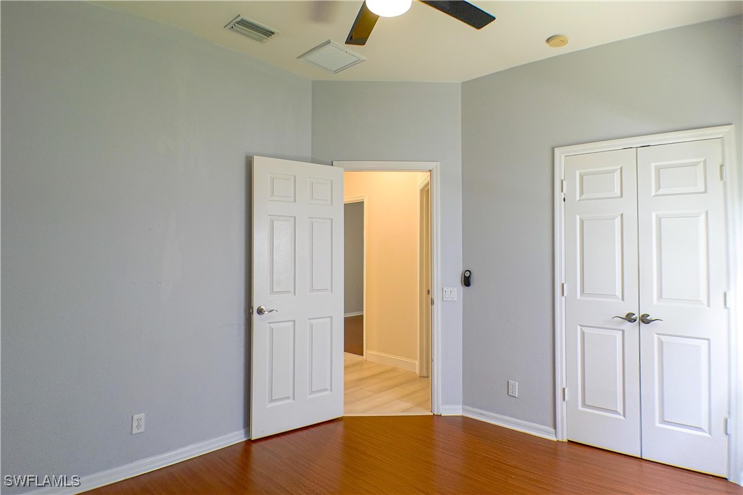 8876 Falcon Pointe Loop Fort Myers, FL 33912 - Photo 21 of 31 an empty room with wooden floor closet and windows