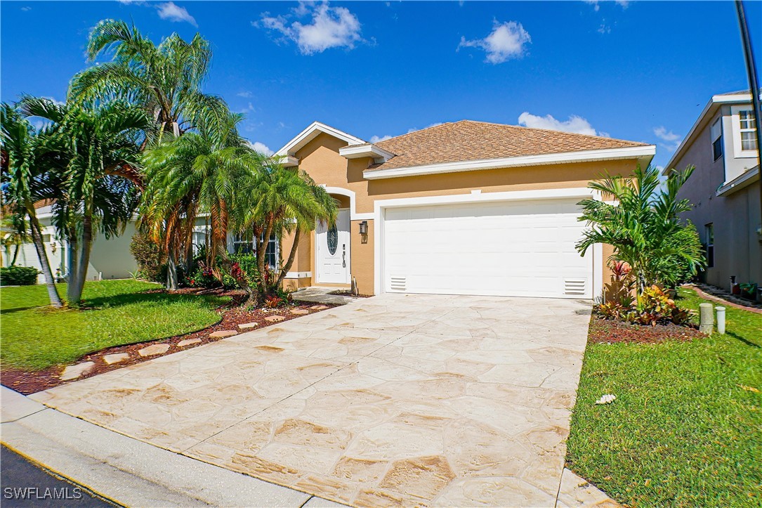 8876 Falcon Pointe Loop Fort Myers, FL 33912 - Photo 3 of 31 a view of a house with a yard and plants