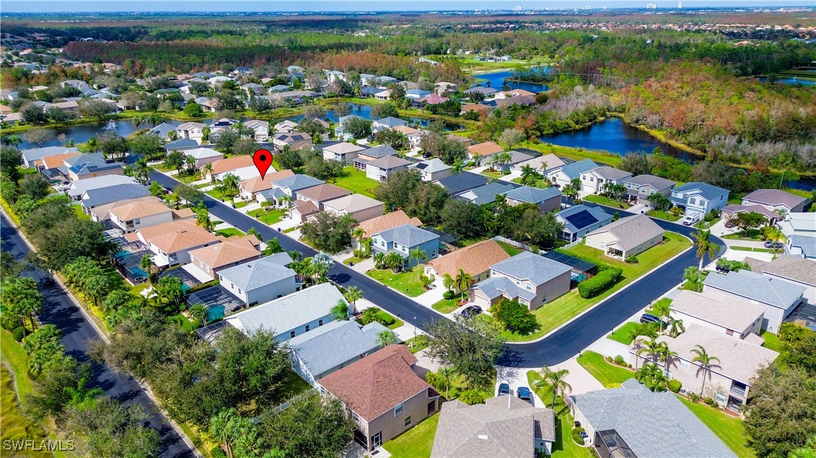 8876 Falcon Pointe Loop Fort Myers, FL 33912 - Photo 31 of 31 an aerial view of a house with a lake