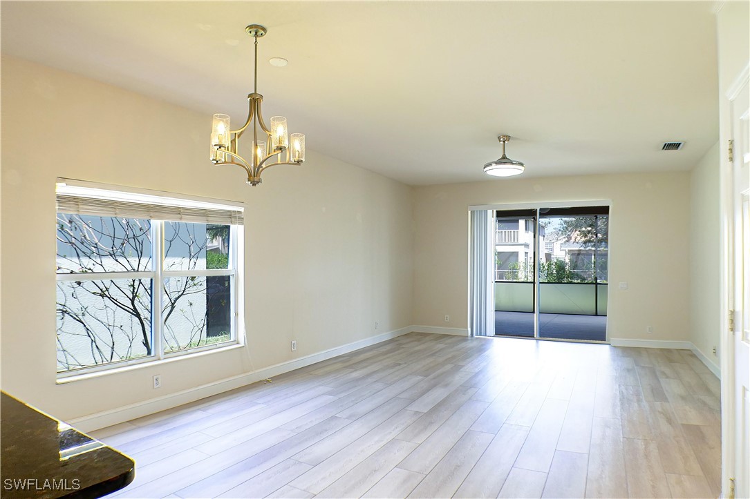 8876 Falcon Pointe Loop Fort Myers, FL 33912 - Photo 4 of 31 a view of livingroom with window wooden floor and front door