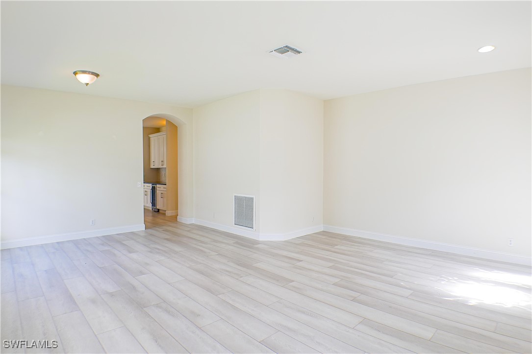 8876 Falcon Pointe Loop Fort Myers, FL 33912 - Photo 7 of 31 a view of an empty room with wooden floor and a window