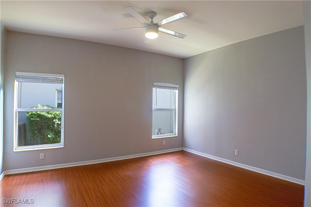 8876 Falcon Pointe Loop Fort Myers, FL 33912 - Photo 10 of 31 a view of an empty room with window and wooden floor