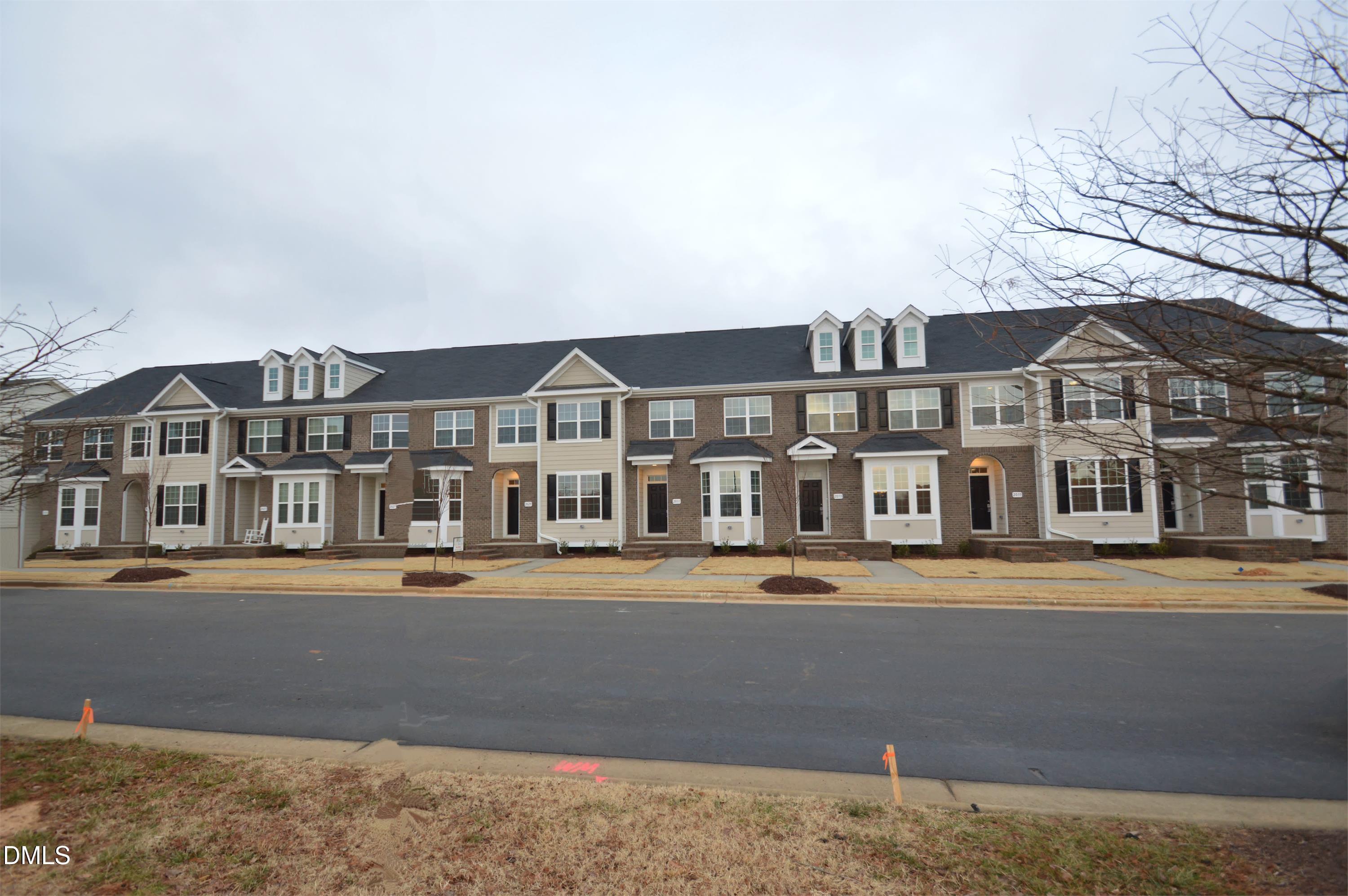 2021 Hayes Lane Holly Springs, NC 27540 - Photo 2 of 25 a front view of a building with street view